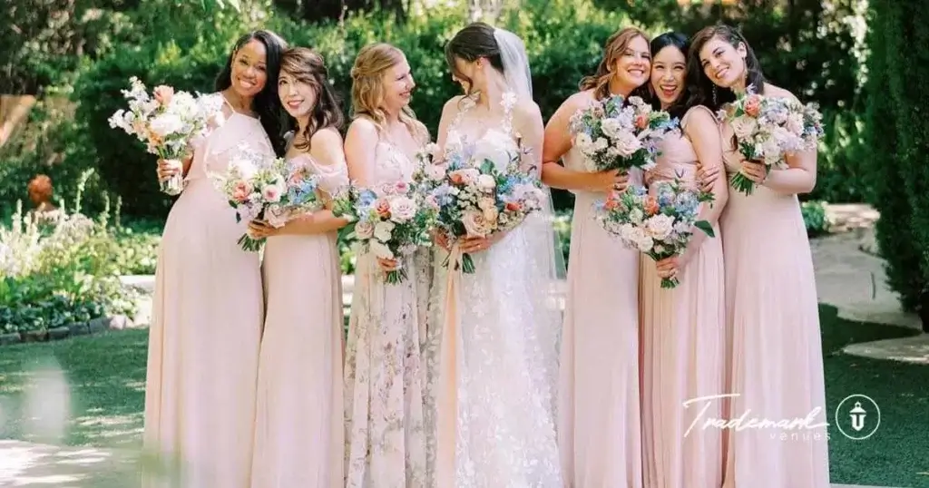 Bridal party taking pre-ceremony portraits together in the natural forest at the Twin Oaks wedding venue.